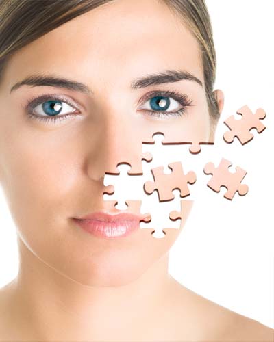 Face of a beautiful young woman with a puzzle collage.